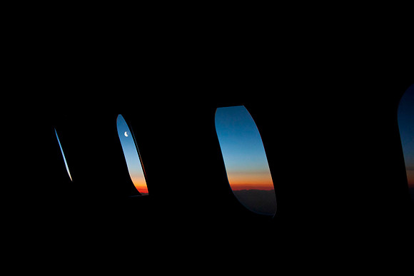 Flying Eastward as the sun chases the moon, over England.